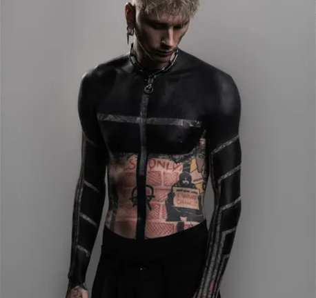 Machine Gun Kelly debuts dramatic upper torso blackout tattoo