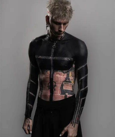 Machine Gun Kelly debuts dramatic upper torso blackout tattoo